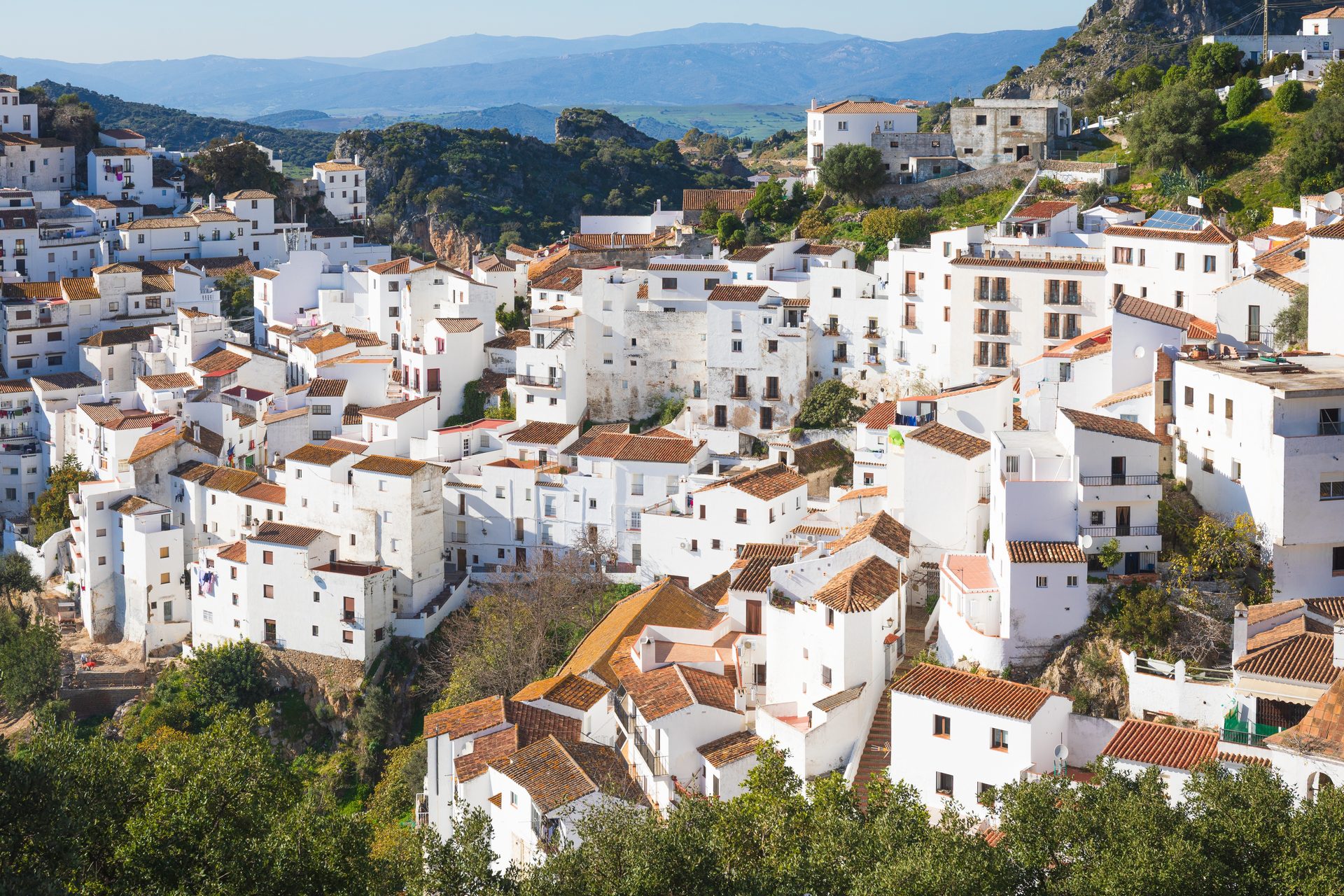 Traditional white-washed house with terracotta roofs, offering scenic mountain views.